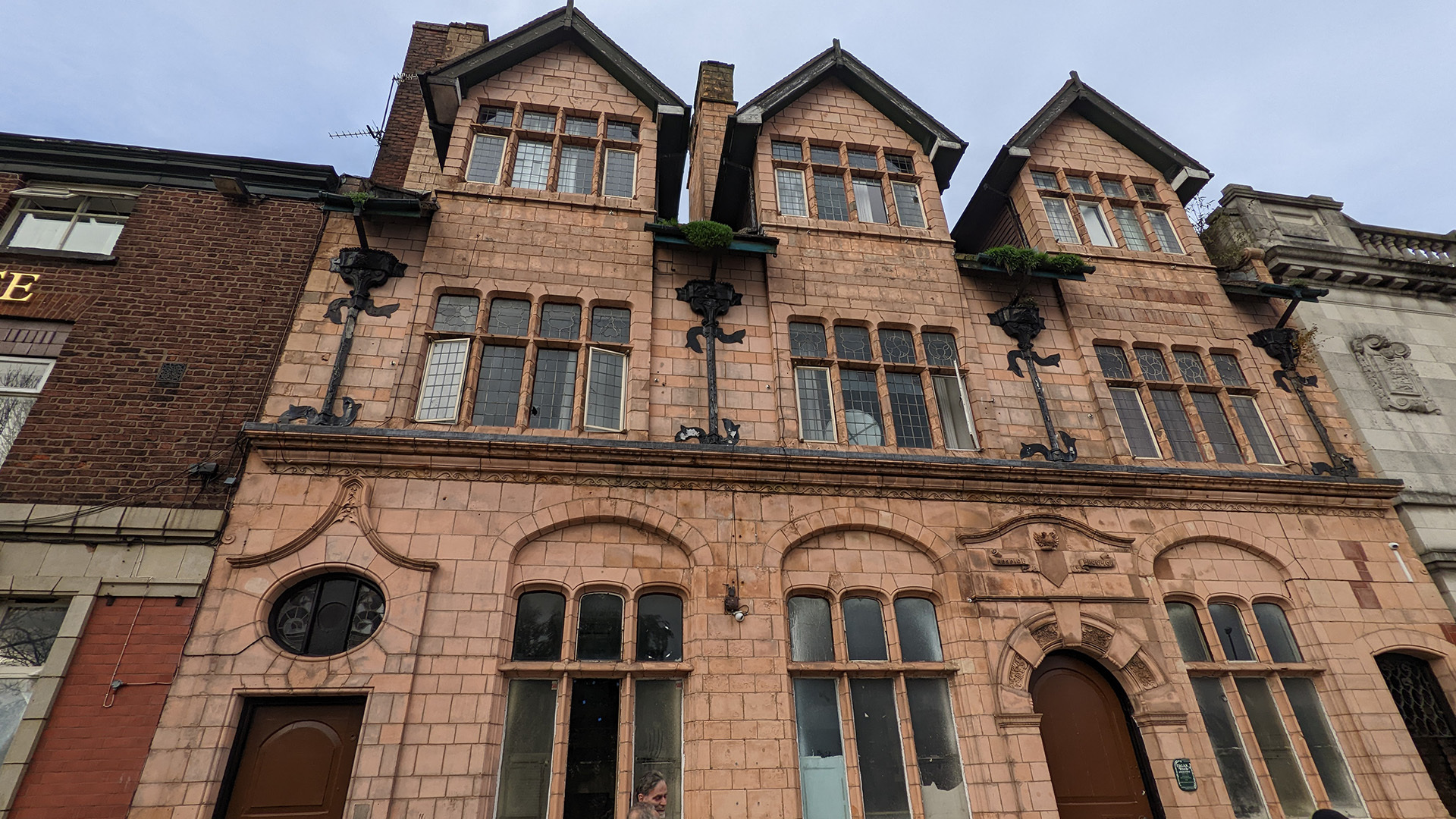 A photograph take during Stephen Marland's urban roam around Middleton. The image looks up at an old brick building in Middleton.