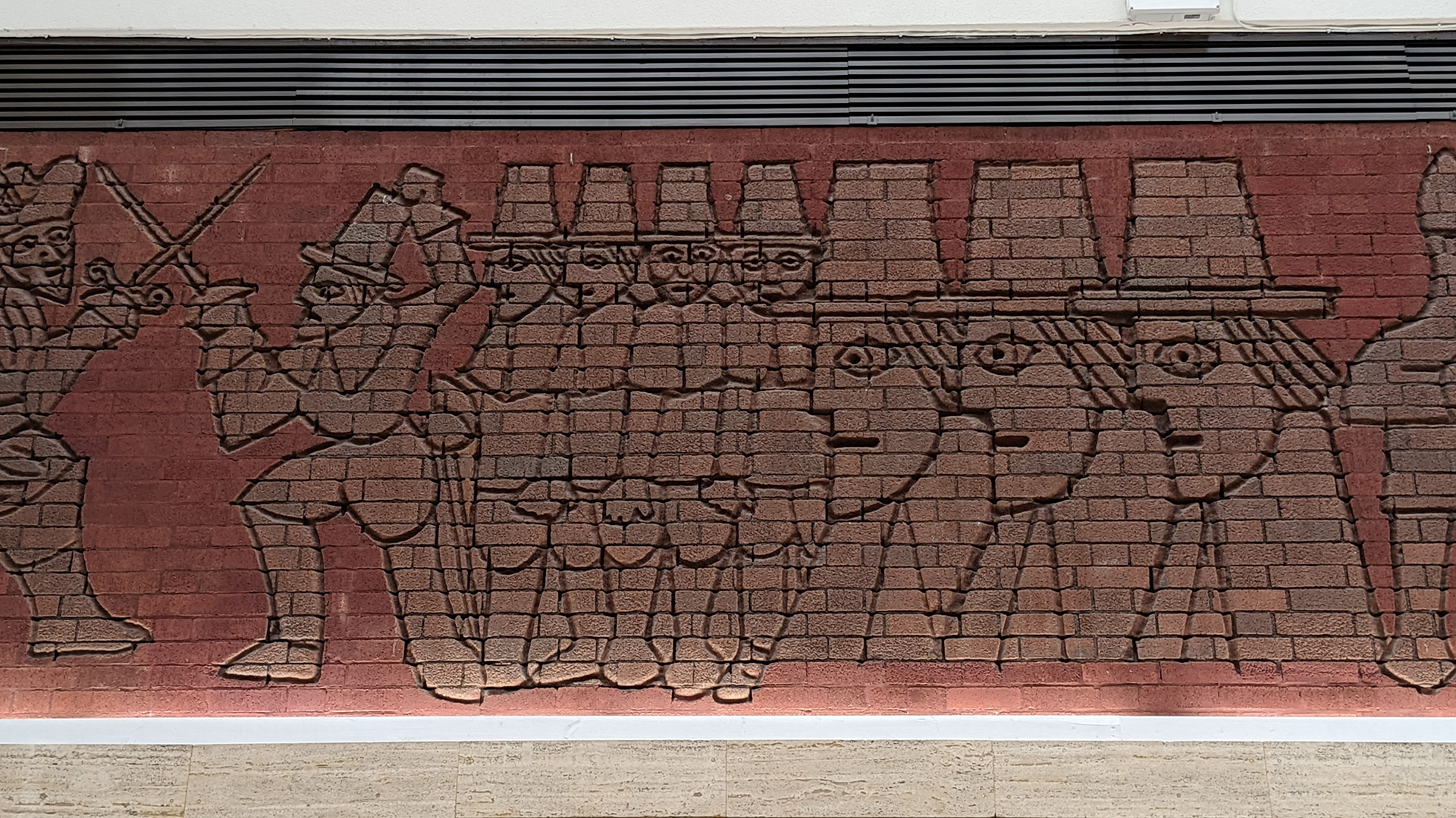 A photograph take during Stephen Marland's urban roam around Middleton. The image shows a red brick mosaic of a simple illustration of a sword fight.